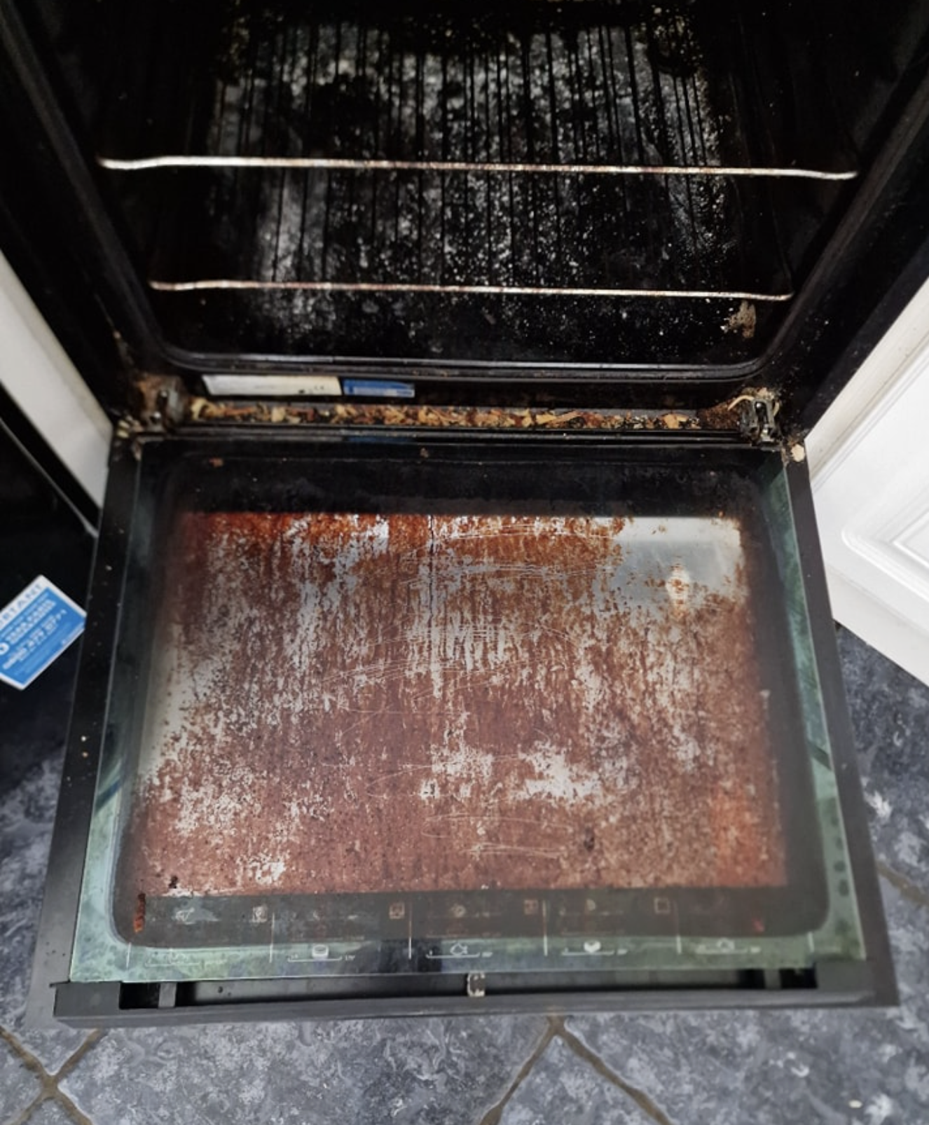 Oven interior before cleaning — burnt-on residue on shelves and walls