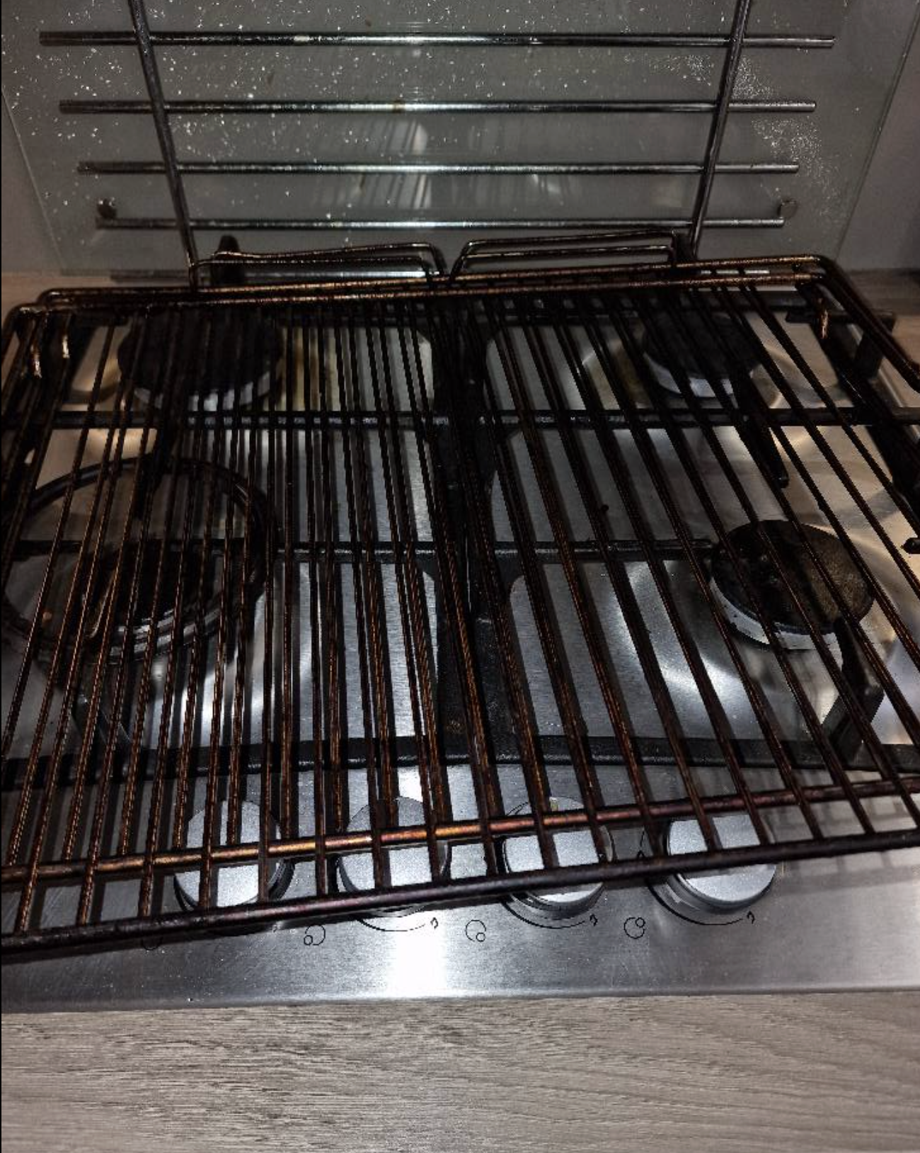 Oven rack before cleaning — dark with baked-on grease